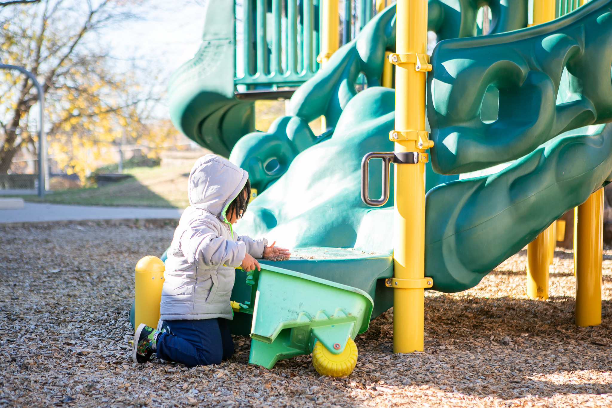 Alex gathering tan bark from the playstructure