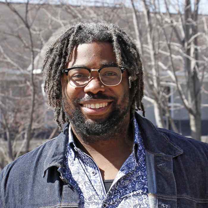 Graydon Francis, Wilder supportive housing staff, smiling with outdoor background