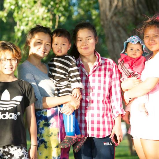 picture of six children and adults smiling and posing