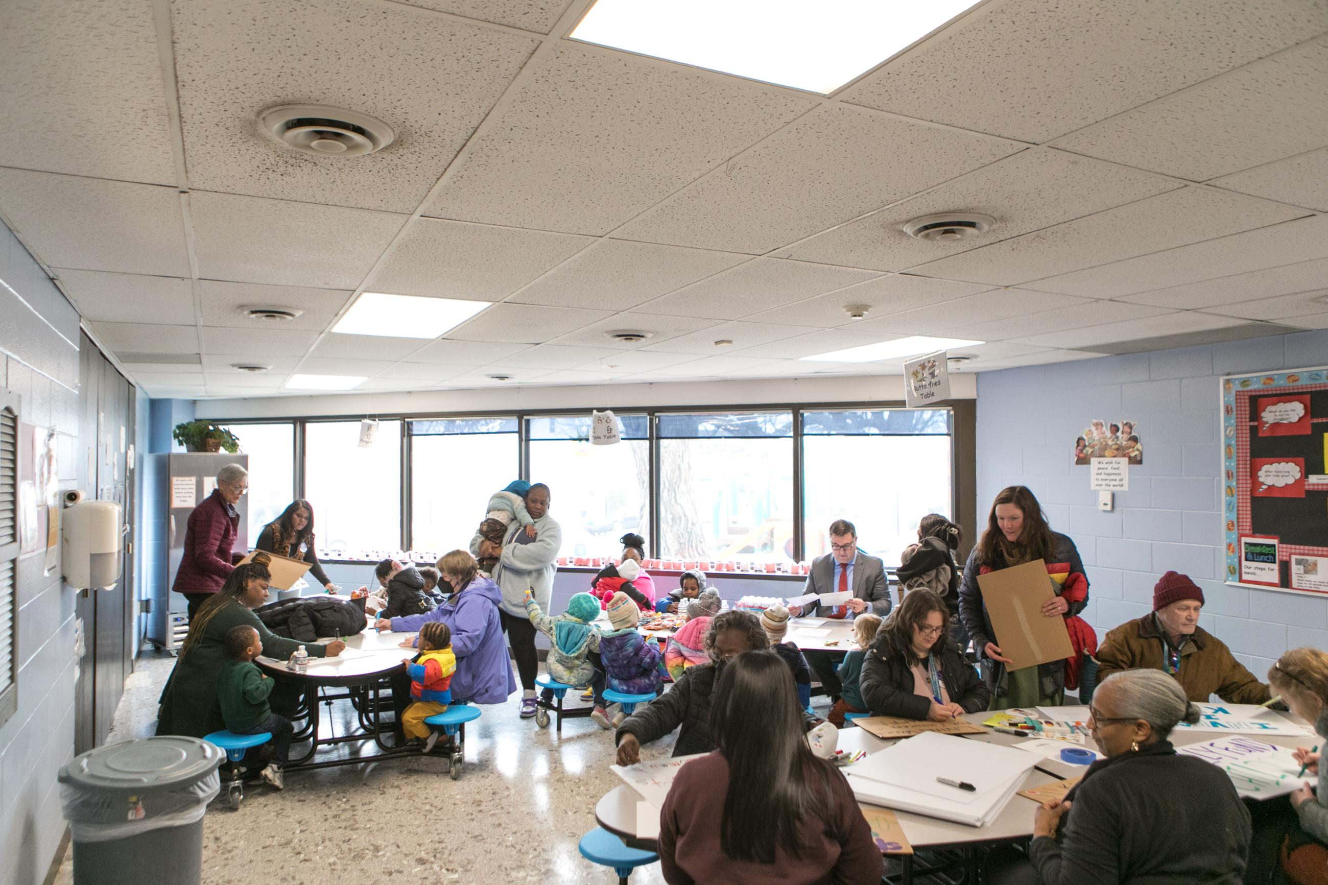 Parents and staff making signs for Day Without Childcare