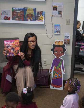 Author Thuba Nguyen reads to children at the Child Development Center